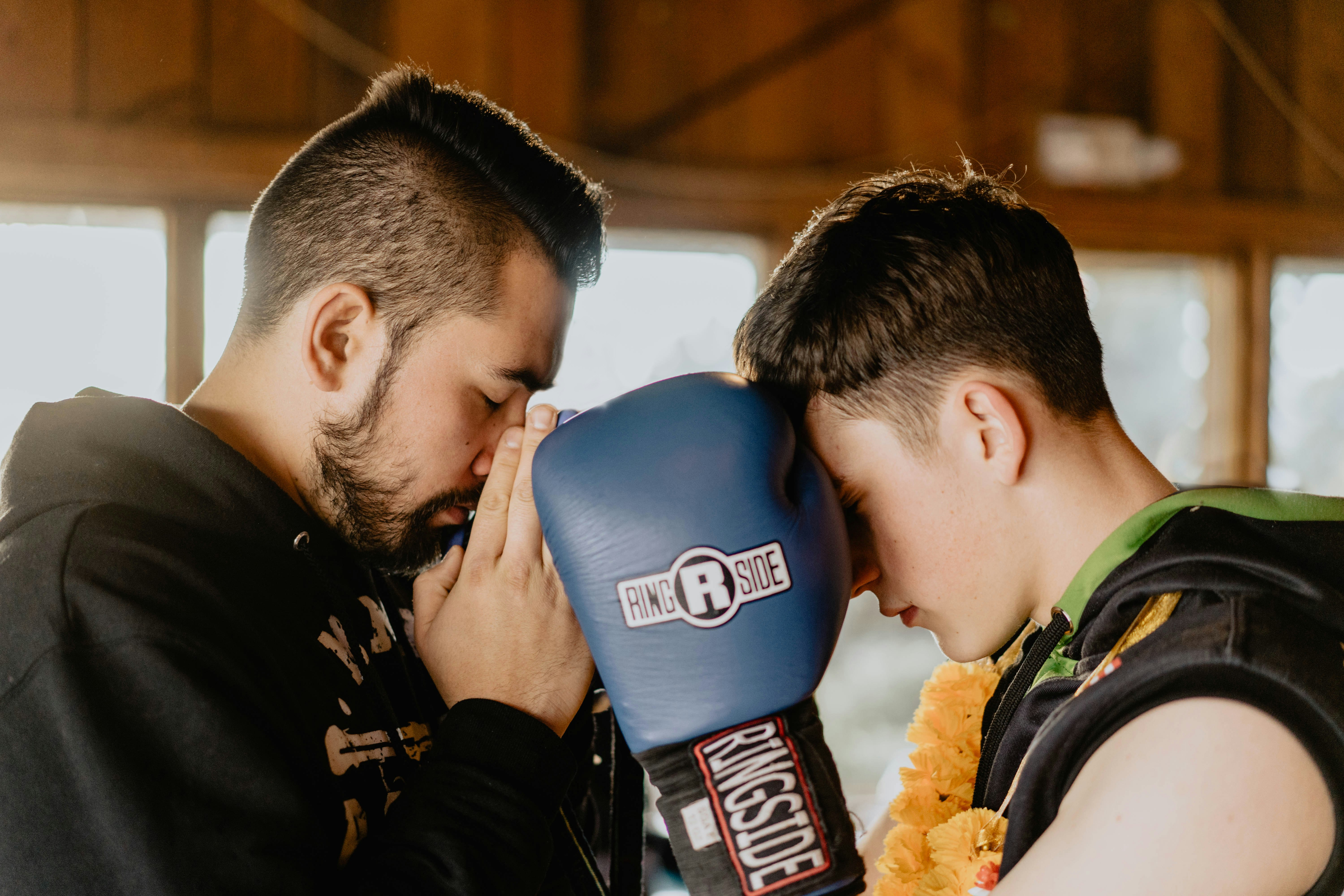 two men praying inside room